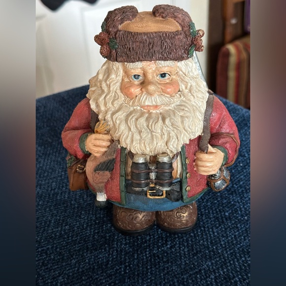 Hunting Santa carries his binoculars and hunting equipment wearing a furry hat - Picture 1 of 8